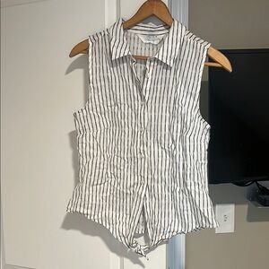 White sleeveless fitted button down top with notched collar